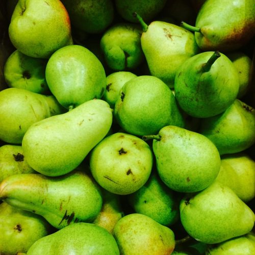 A vibrant collection of fresh green pears showcasing their natural textures.